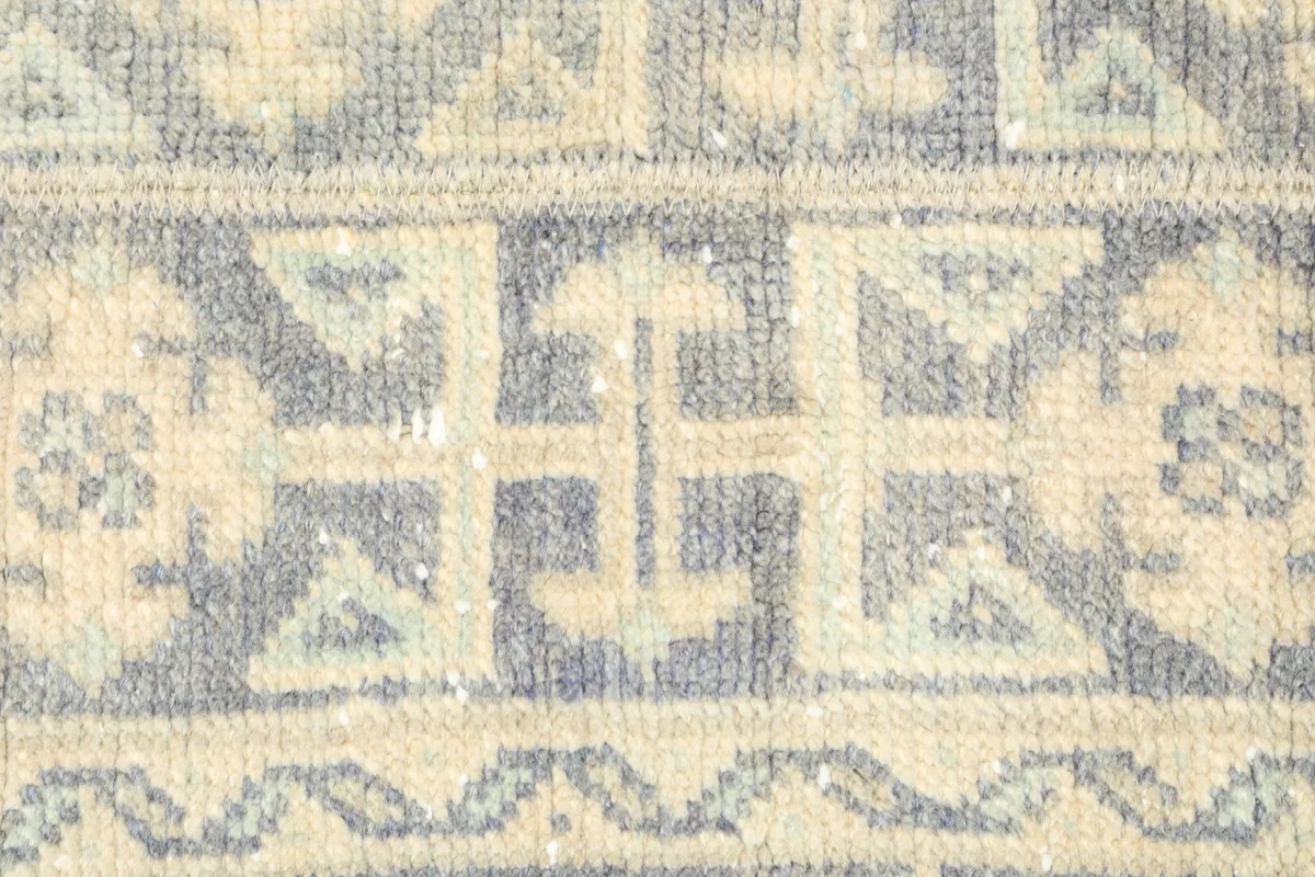 Detailed view of the central geometric motifs and border design