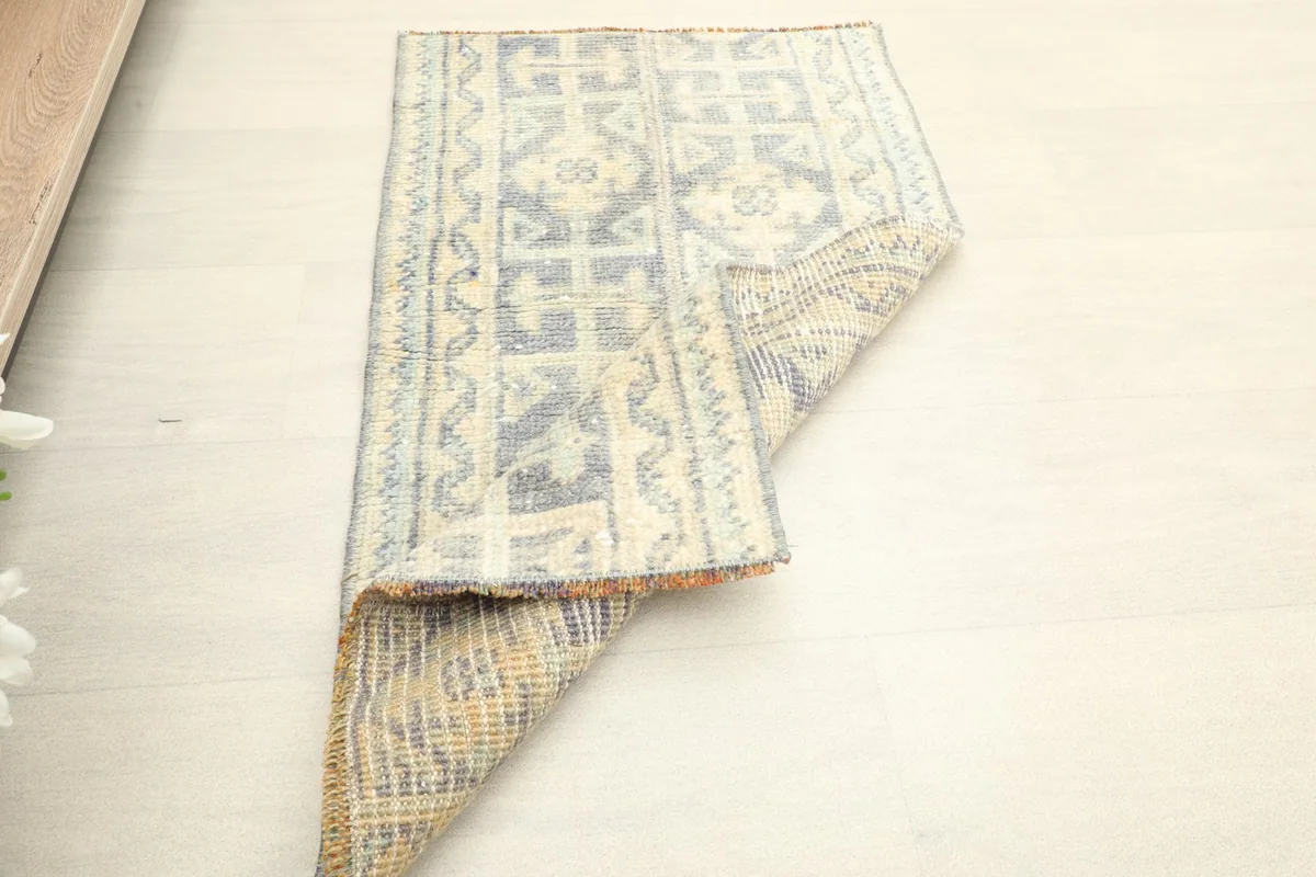 Rug partially folded, revealing the reverse side construction