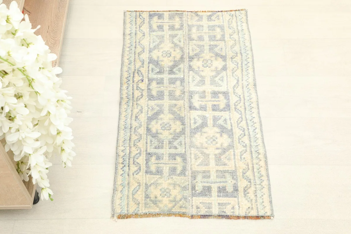Overhead view of the blue and ivory vintage rug on a light floor