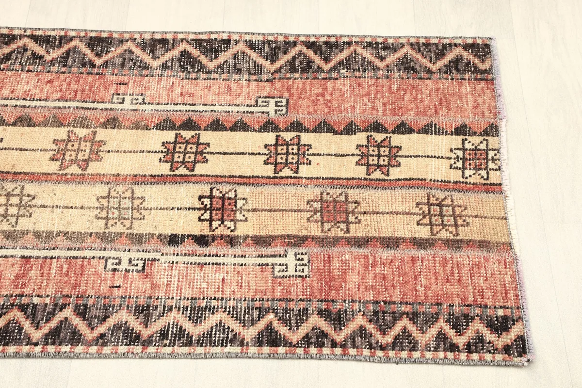 View of the other end of the rug, displaying the full pattern repeat and color variation.