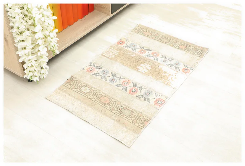Full top view of the beige striped patchwork Anatolian rug on a white background.