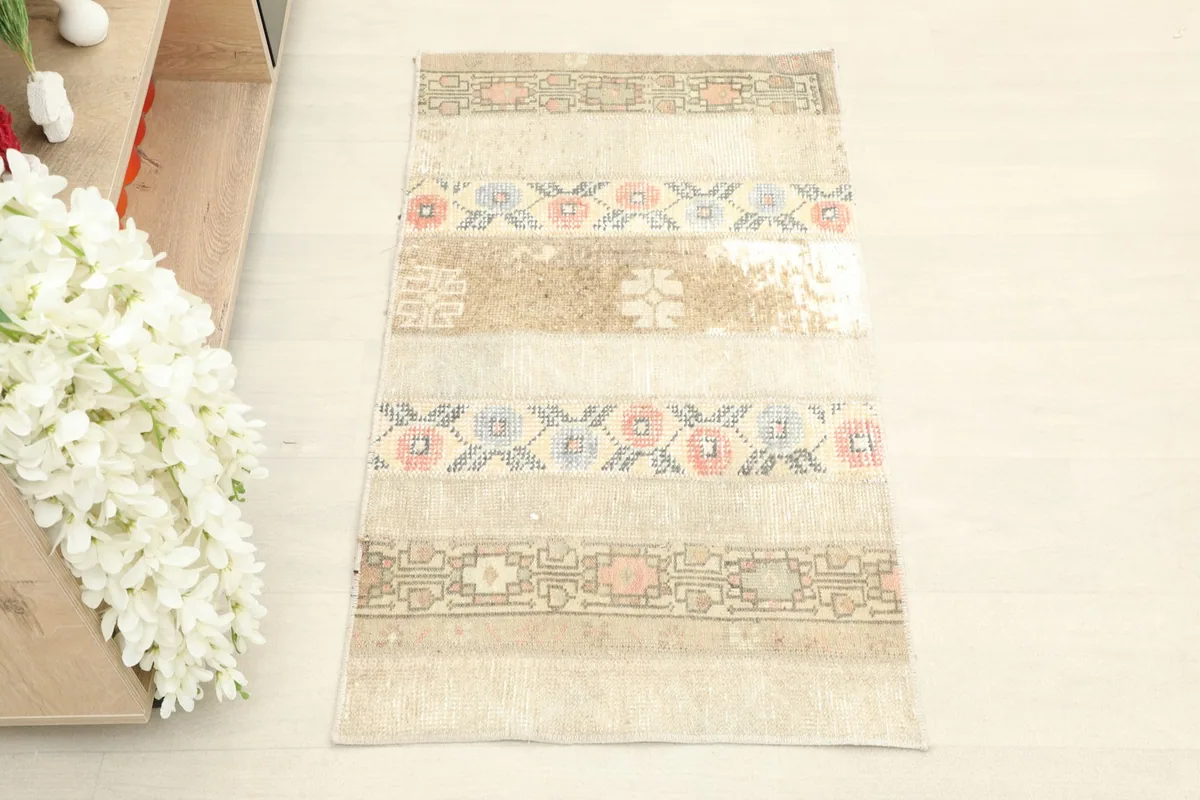 Overhead view showcasing the full length and width of the vintage beige rug.