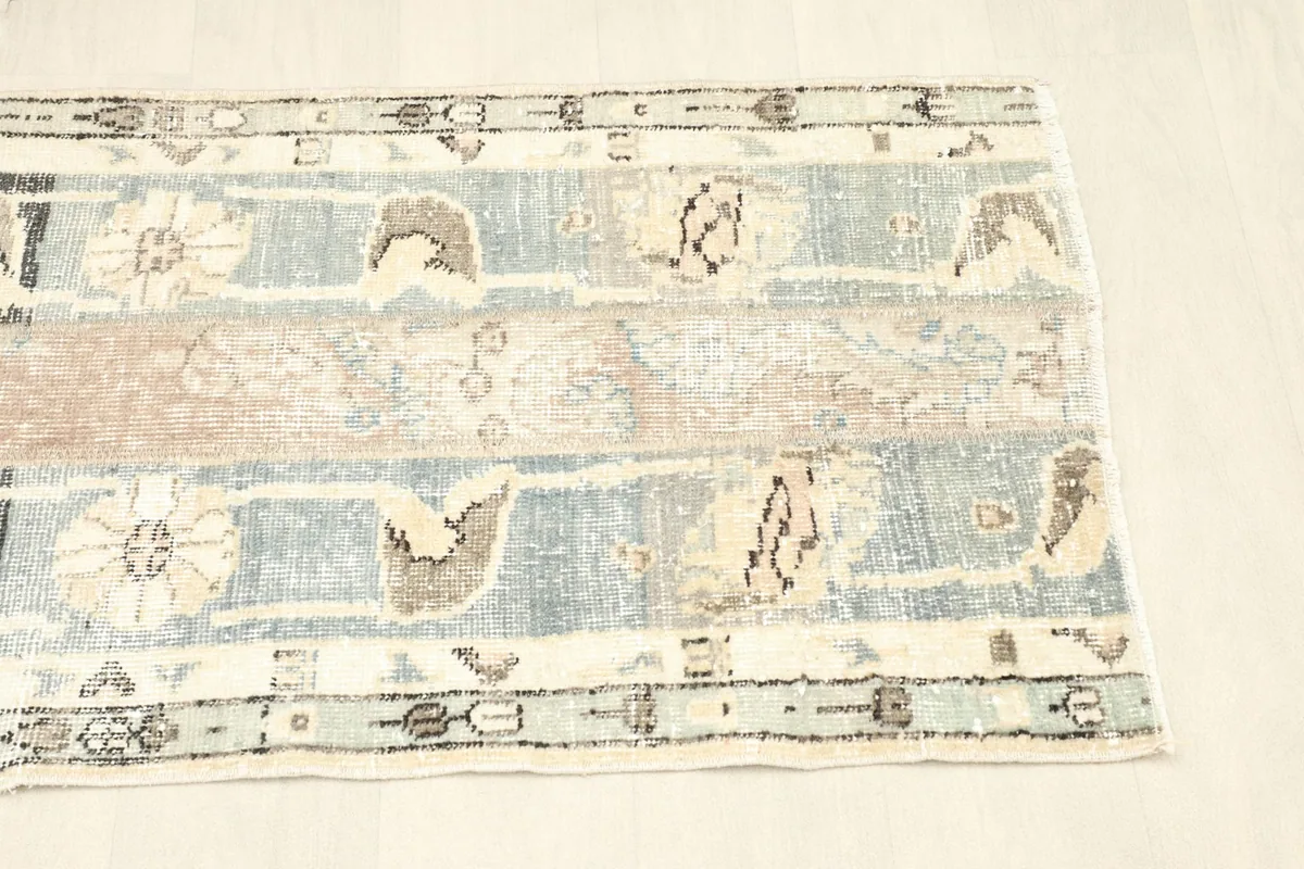 Angled shot from one end of the rug, displaying its overall composition and border details.