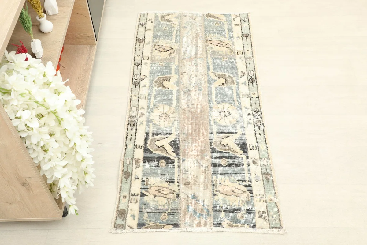 Overhead view of the hand-knotted wool rug, showing its unique patchwork pattern and colors.