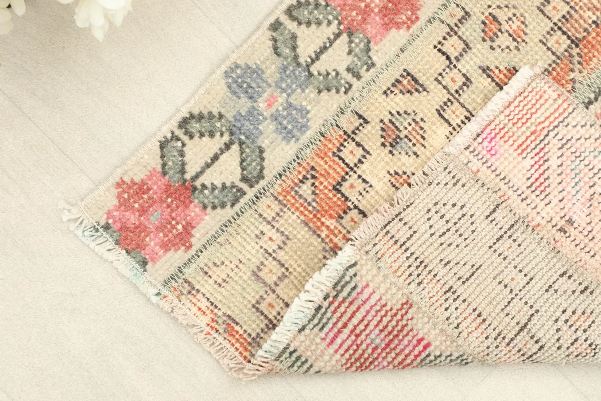 Corner of the runner folded to show the wool pile on cotton foundation and the reverse side.