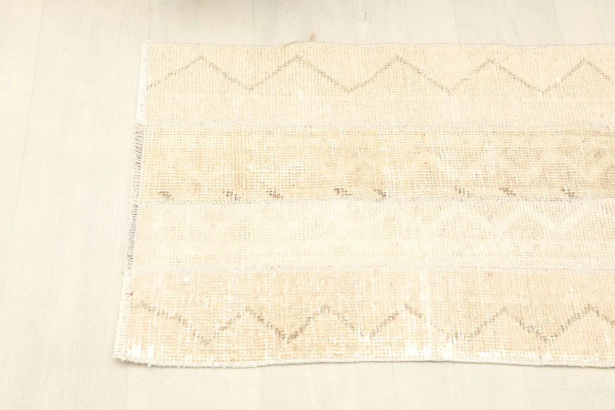 Another angled view of the rug, showing the subtle color variations and geometric lines.