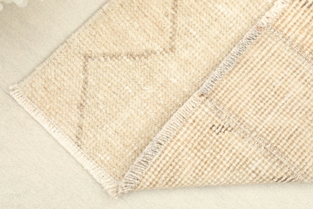 View of the rug's underside, revealing the hand-knotted construction and cotton foundation.