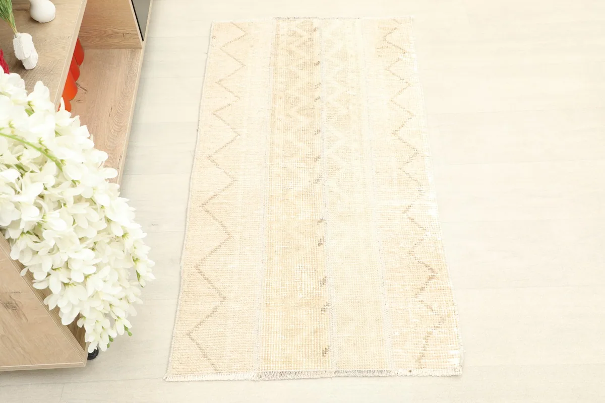 Overhead view showcasing the full pattern and shape of the beige vintage Anatolian rug.