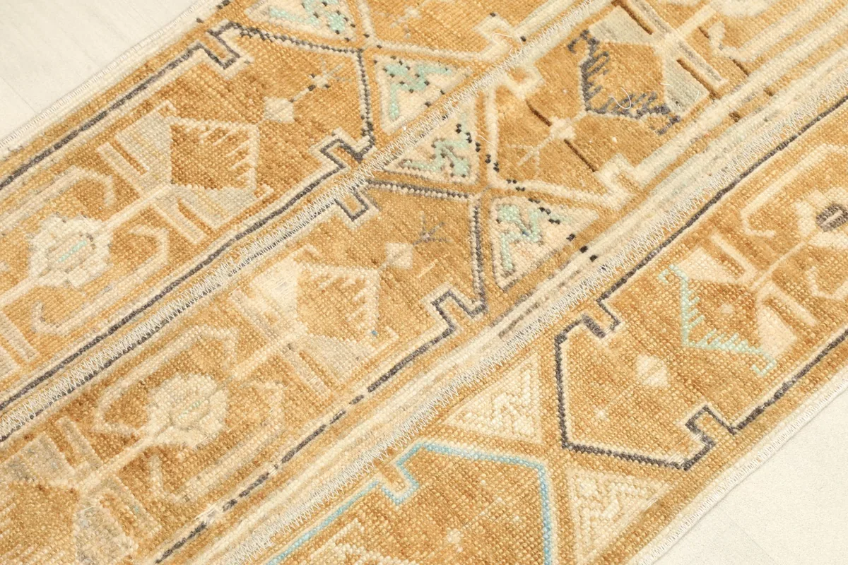 Angled close-up showing the varied geometric motifs and weave texture