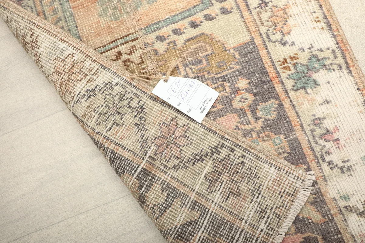 Close-up of the folded rug end, revealing the reverse side and the hand-knotted detail.