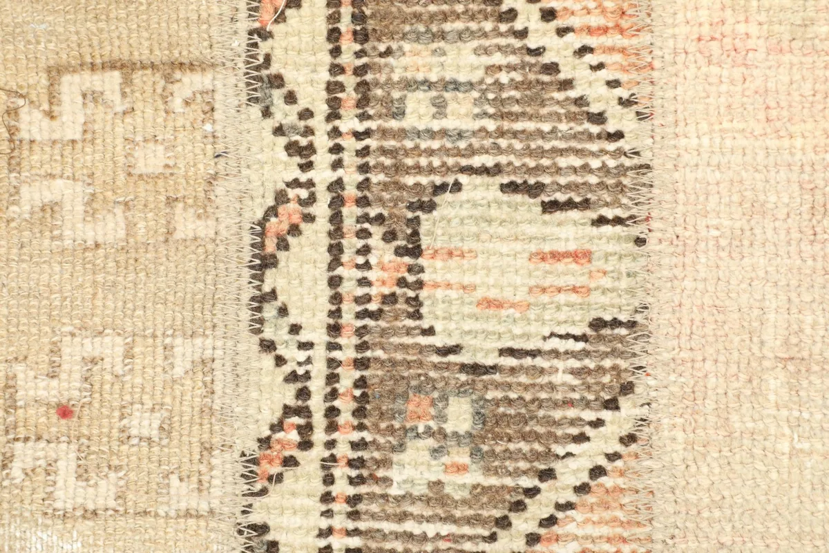 Detailed view of the intricate tribal patterns and colors in one of the brown and rust sections.