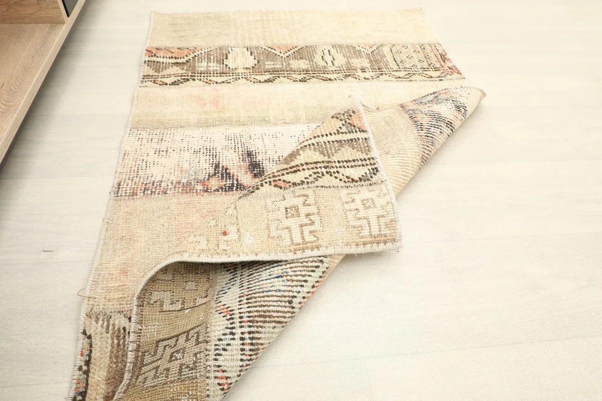 Another folded view of the rug, showing the reverse side and the distinct edge finishing.