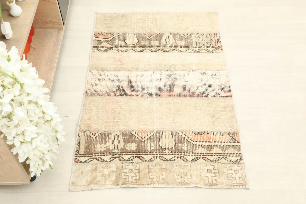 Straight overhead view of the vintage area rug, highlighting its patchwork construction and colors.