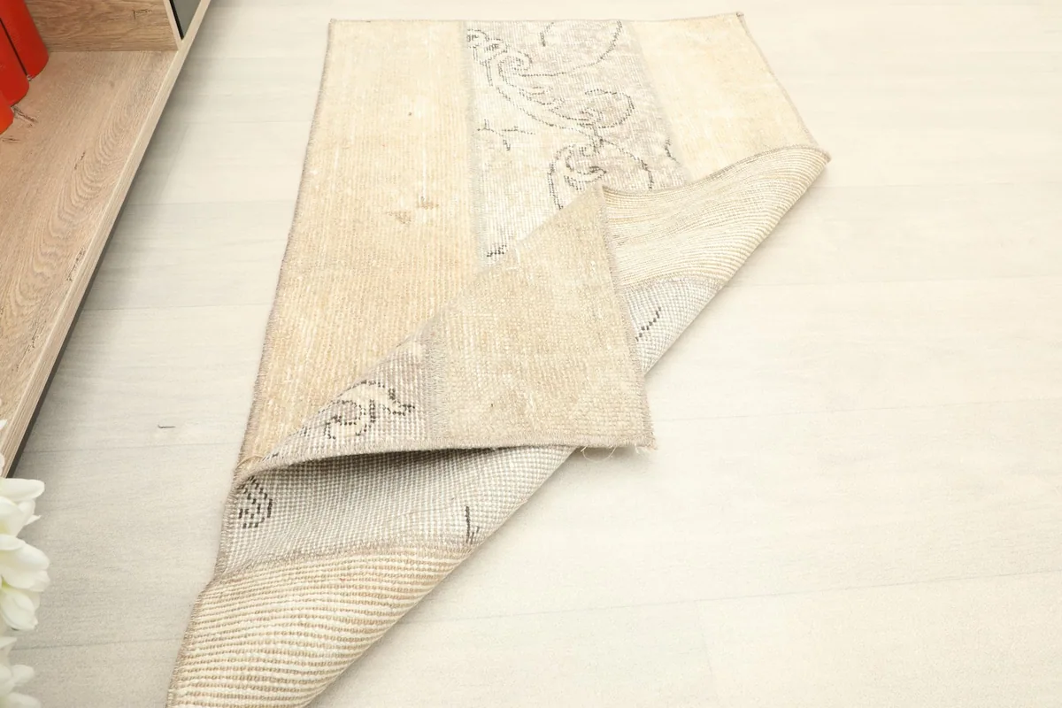 Rug folded to show the thickness and flexibility of the vintage hand-knotted construction.