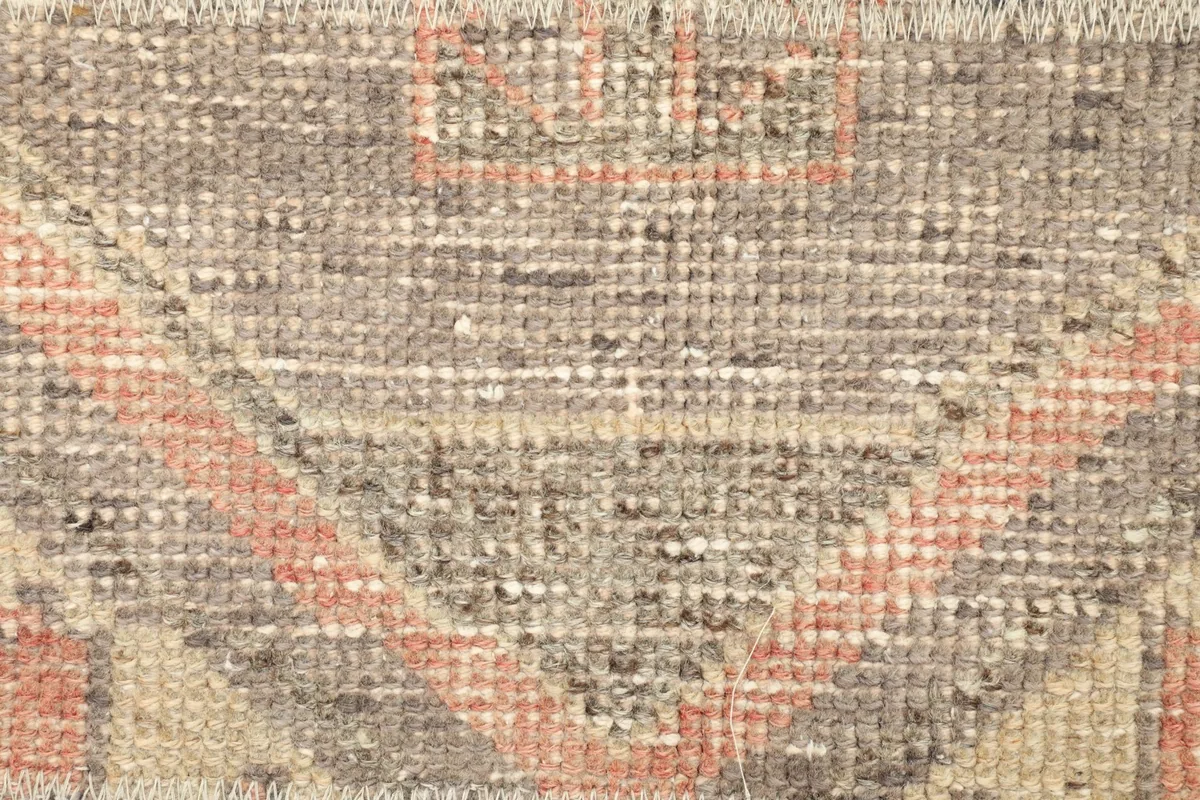 Detailed close-up of the low wool pile, showing individual knots and subtle color variations.