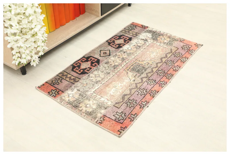 Full top view of the 2x4 orange and pink patchwork vintage rug on a white background.