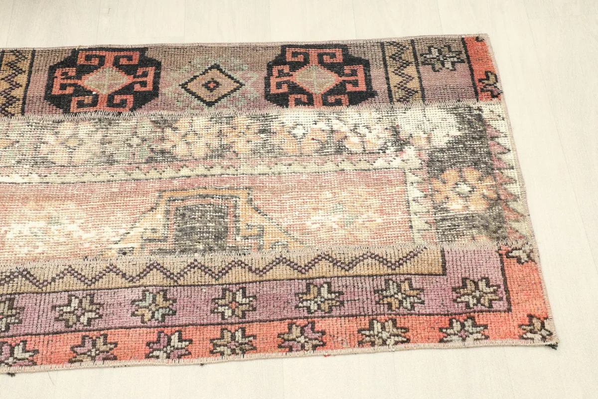 Angled shot of the rug's surface, emphasizing the distressed appearance and unique color blending.