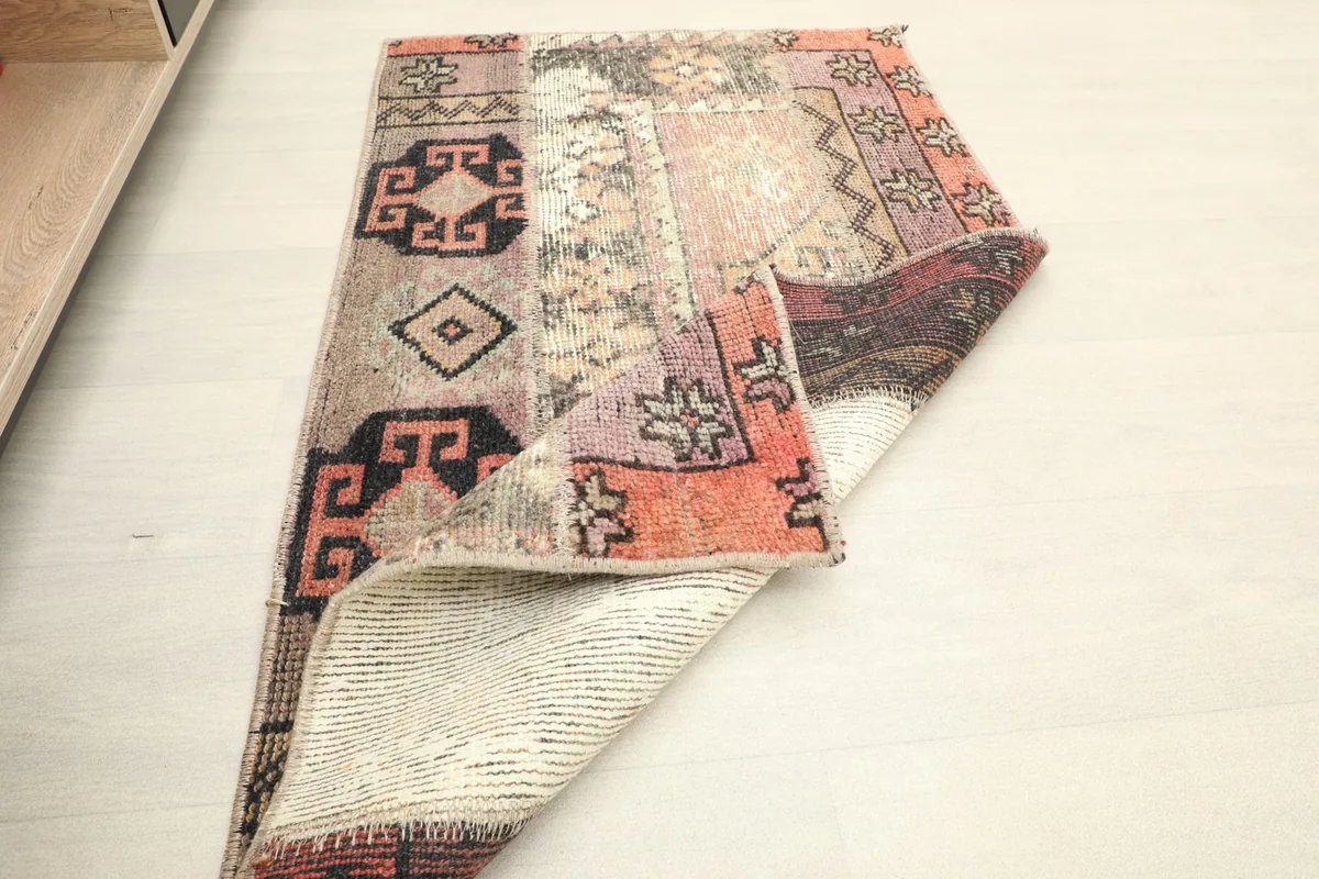 Rug partially folded, displaying both the front design and the clean, woven back.