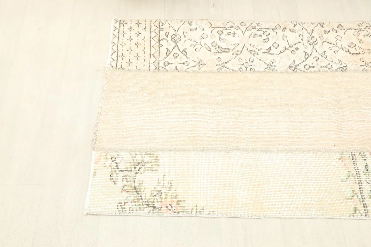 Angled view from the left side of the rug, showcasing the full length and patchwork construction.