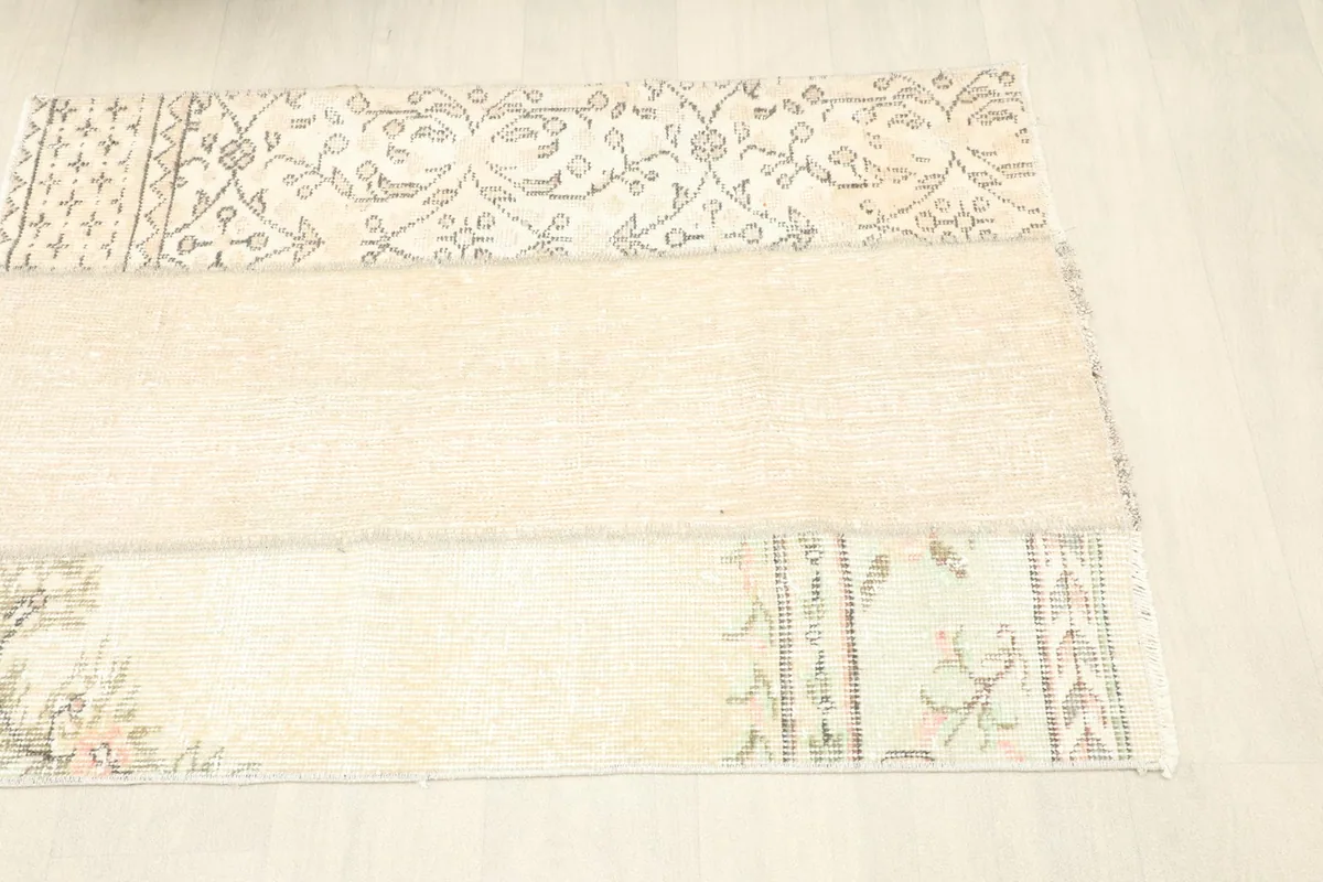 Angled view from the right side of the rug, highlighting the distinct panels and their motifs.