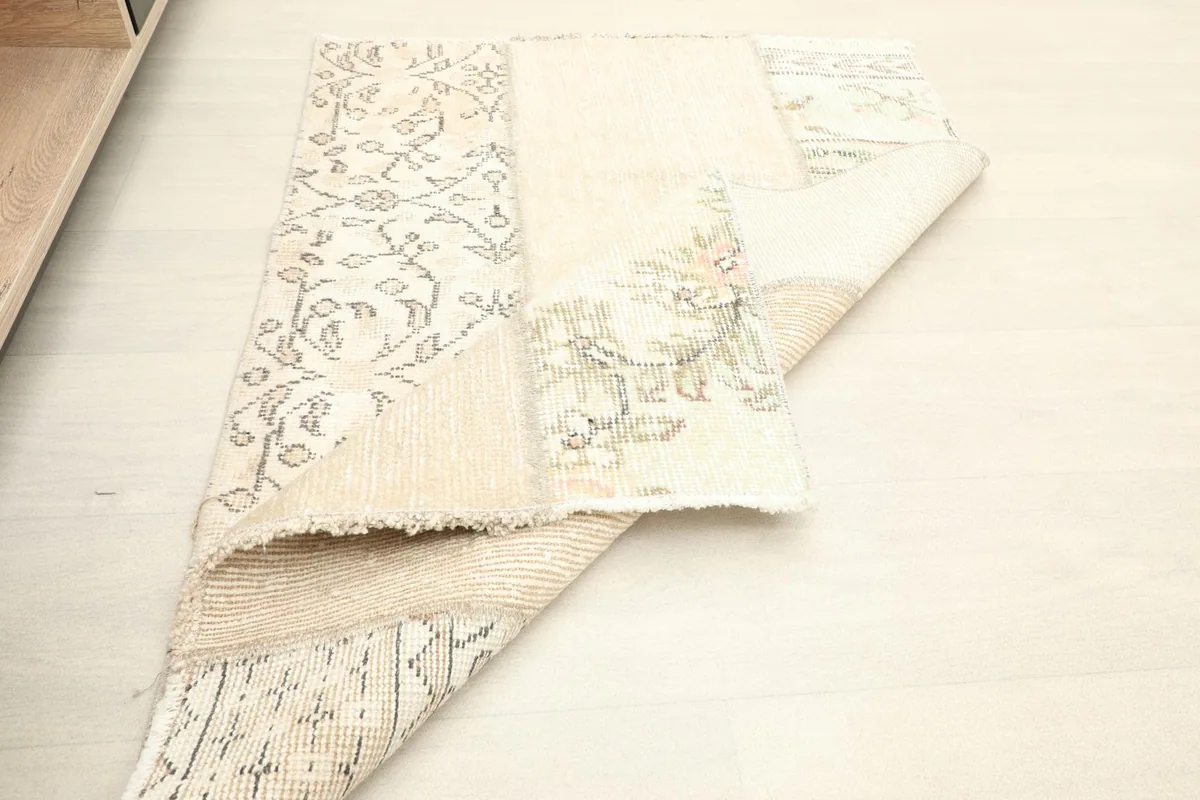 Rug folded to reveal the foundation and the texture of the hand-knotted construction.