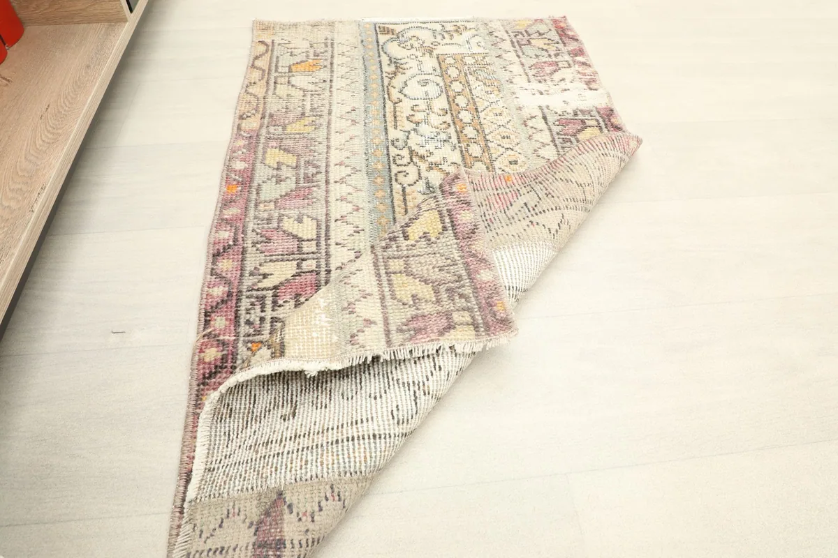 Rug folded to display its flexibility and the density of the wool pile.