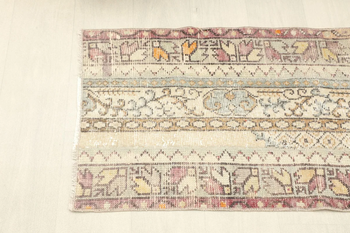 Overhead view of one end of the rug, showing the rose and orange border patterns.