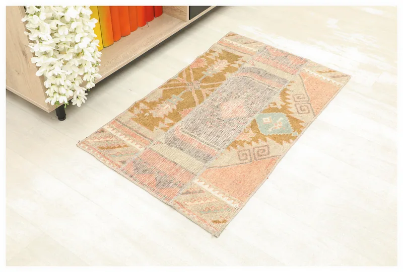 Full overhead view of the beige and rust vintage Anatolian rug on a white background