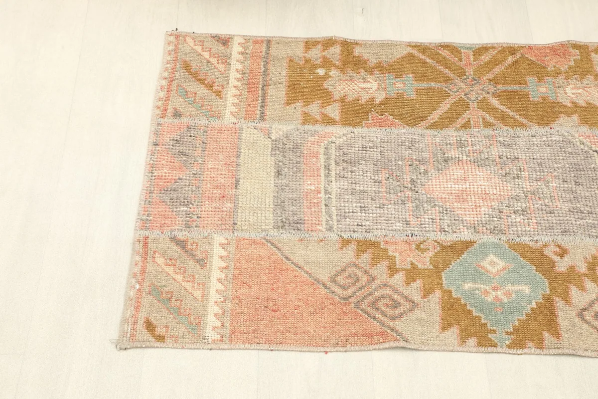 Angled view of the rug from the side, showing the blend of rust, beige, and brown tones
