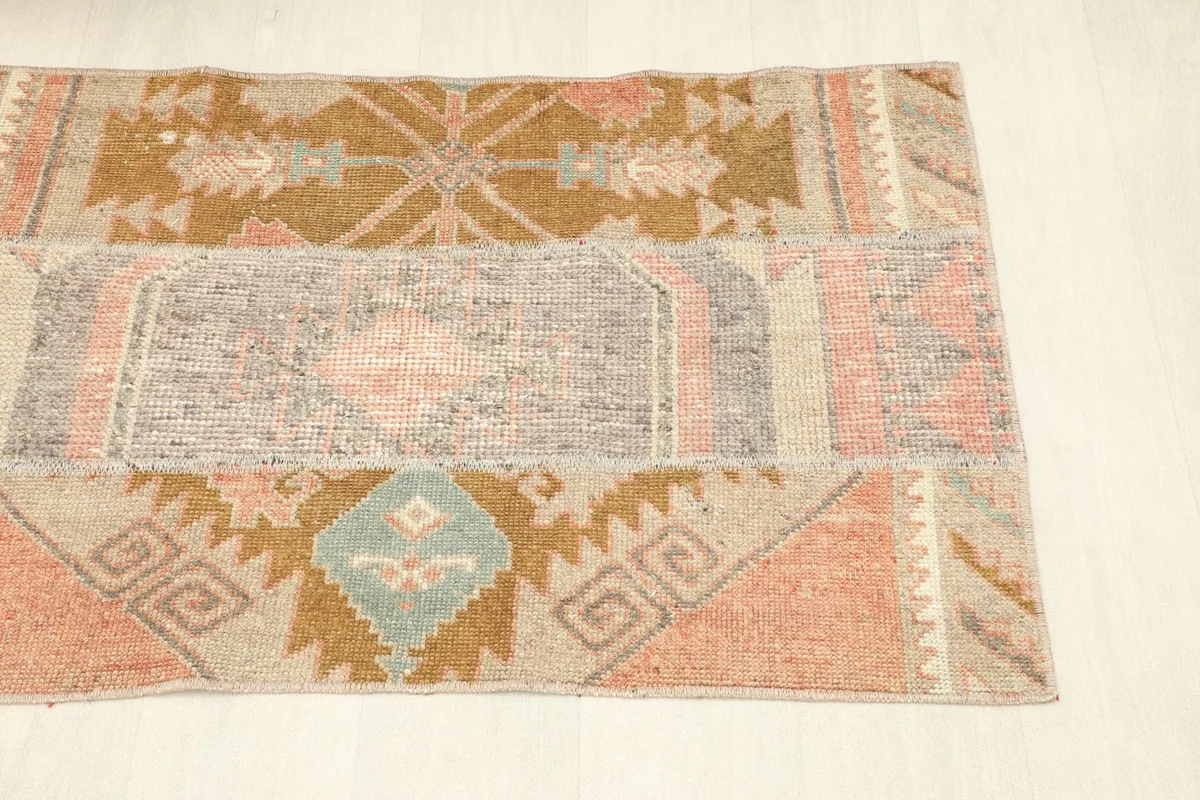 Angled view of the rug, emphasizing the varied geometric patterns and color blocks