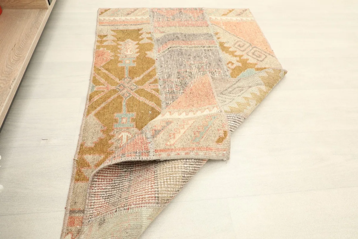 Rug partially folded, displaying the overall design and the integrity of the vintage weave