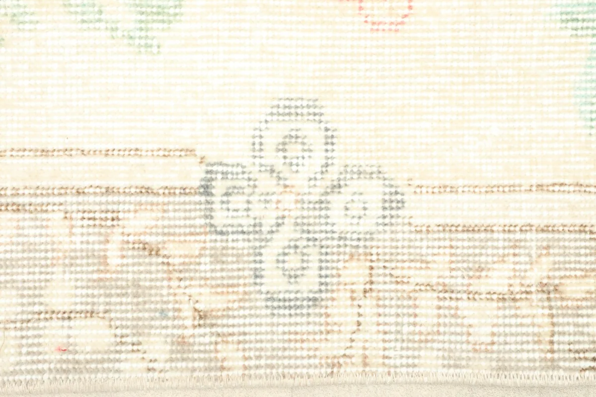 Detailed view of the hand-knotted construction and subtle geometric patterns in the beige panels.