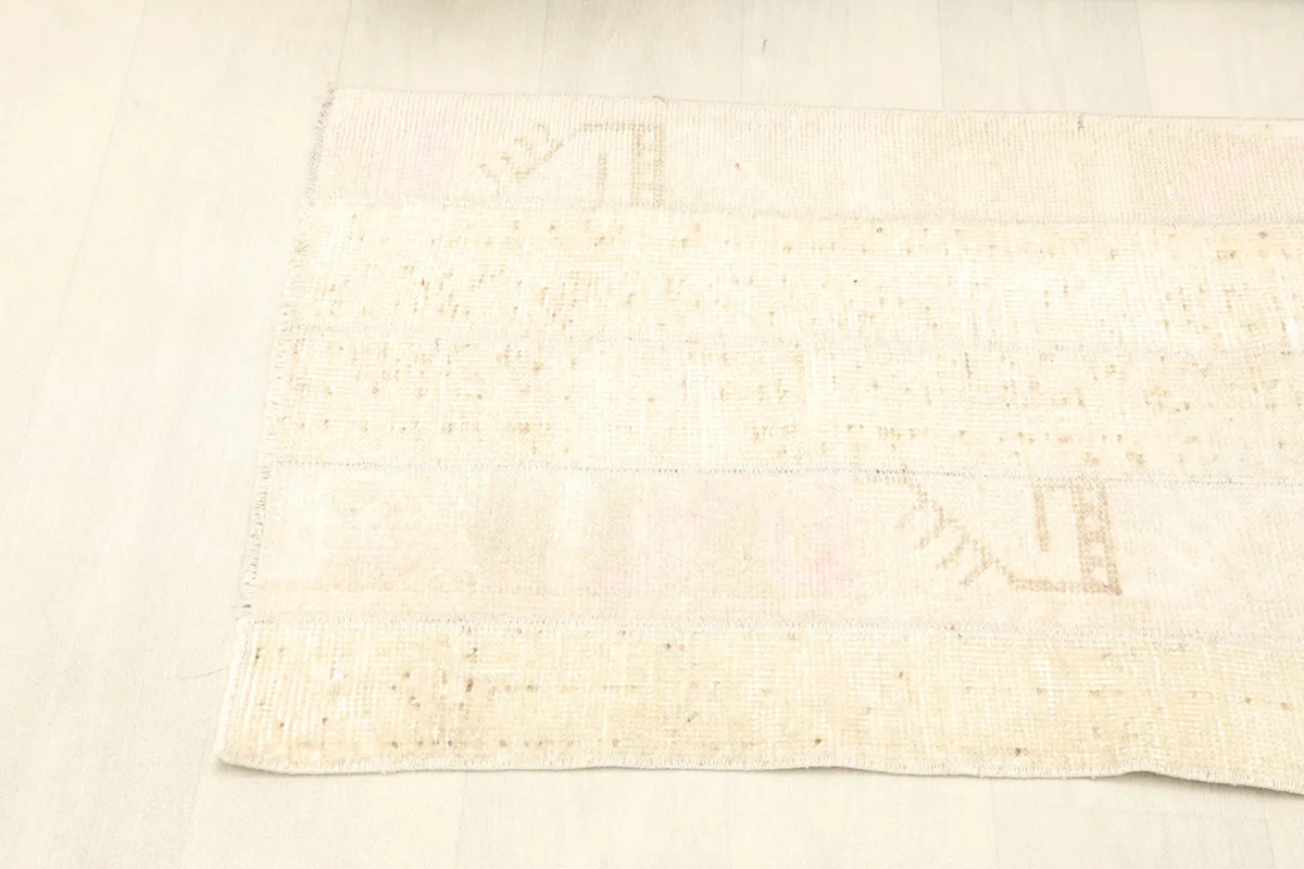 Another angled view of the rug, emphasizing its vintage patina and soft color variations