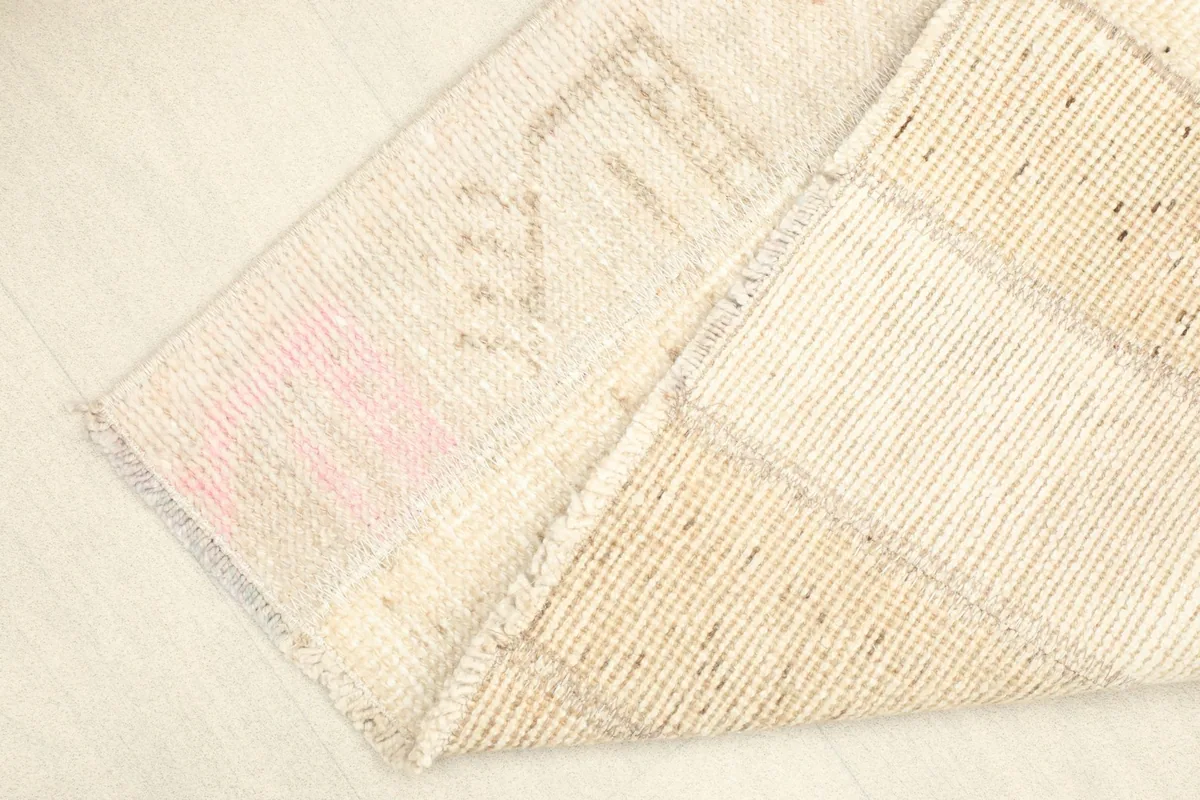 View of the rug folded to show the hand-knotted wool pile and cotton foundation
