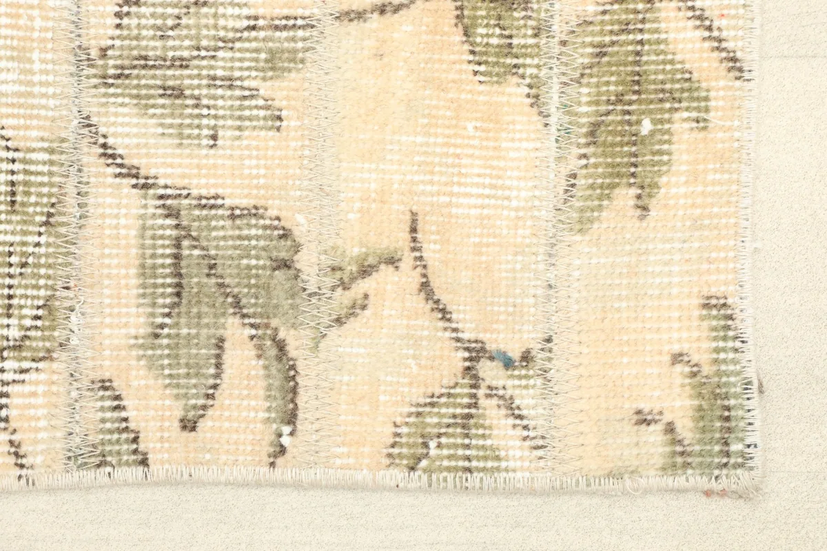 Close-up detail of the rug's corner, showing the hand-knotted pile and subtle color variations.