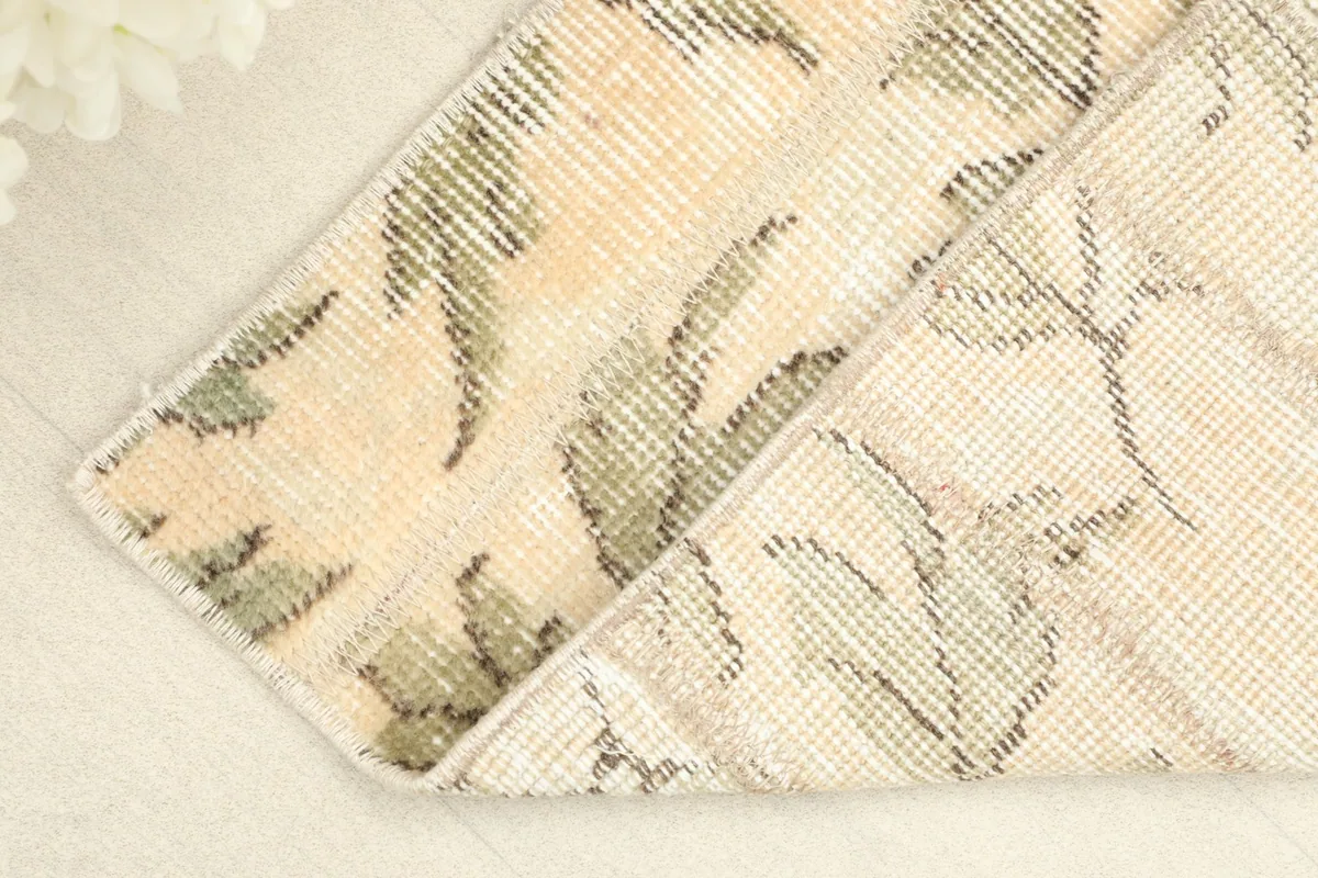 View of the rug's back, revealing the cotton foundation and the reverse of the knots.