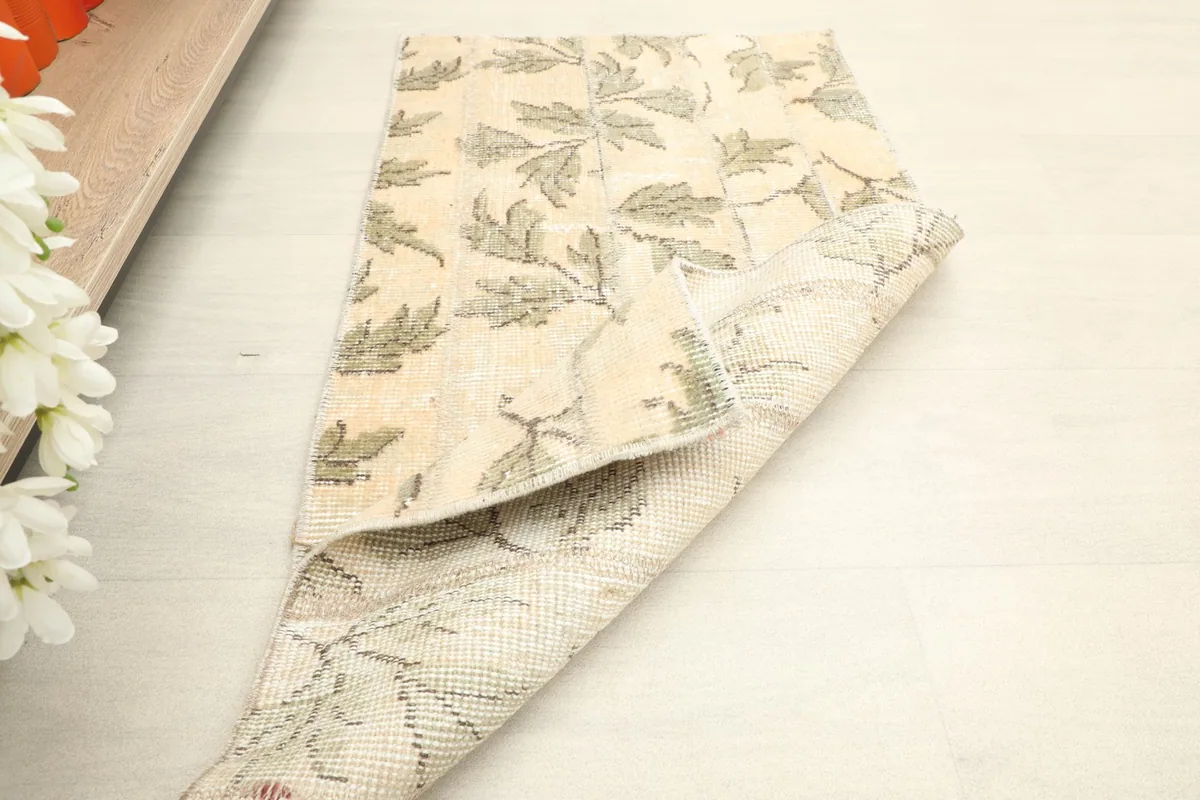 The rug partially folded, showcasing both the front design and the back construction.