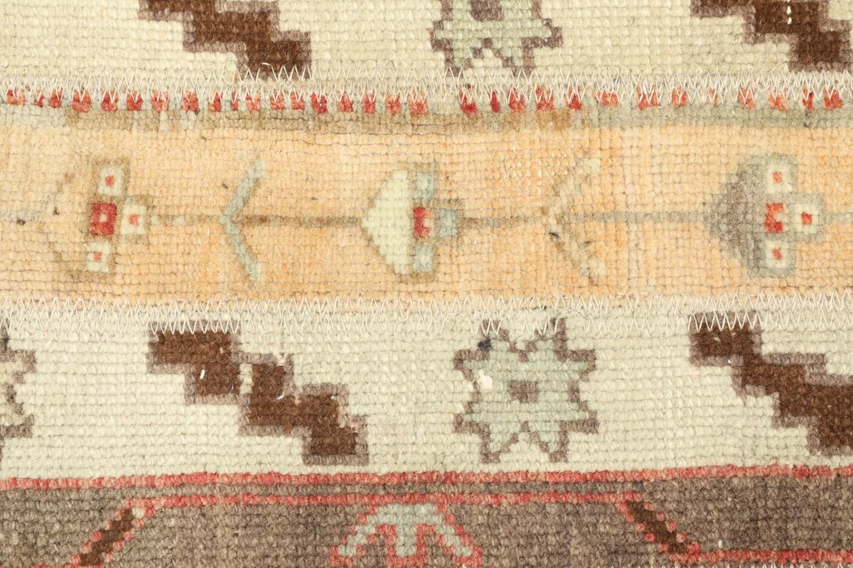 Detailed shot of the wool pile and hand-knotted texture, showing individual geometric symbols
