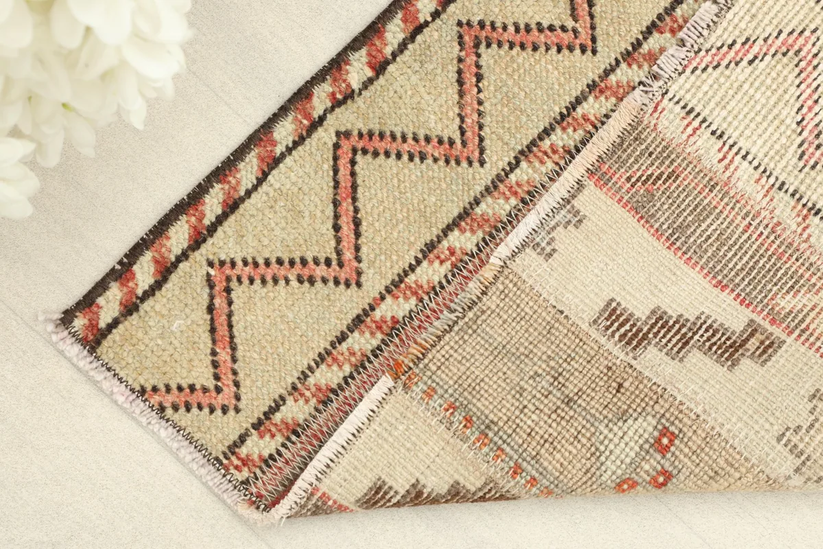 View of the rug's underside, revealing the hand-knotted construction and cotton foundation