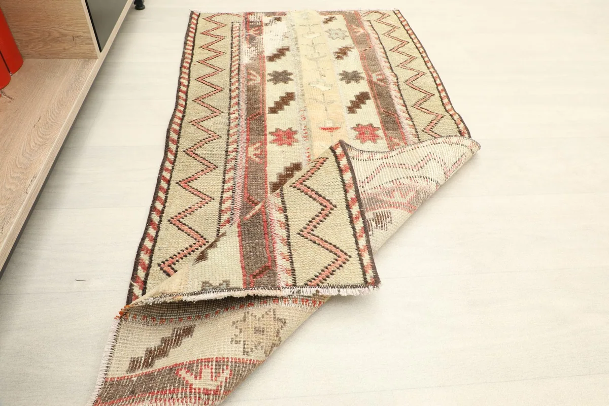 The rug folded to show its flexibility and thickness from an angled perspective