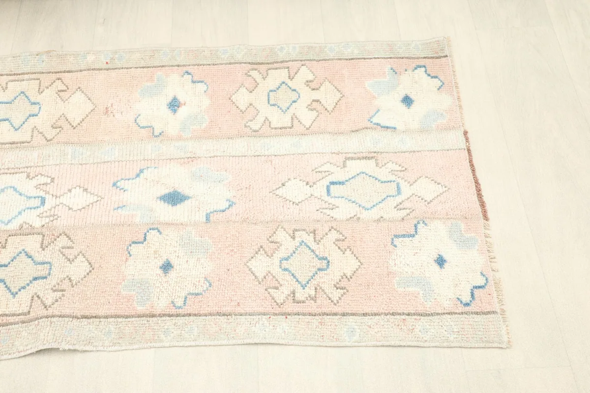 Angled perspective of the rug, showcasing its full length and repeating tribal patterns.