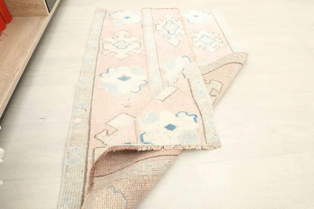The rug partially rolled, demonstrating its pliable nature and the overall design.