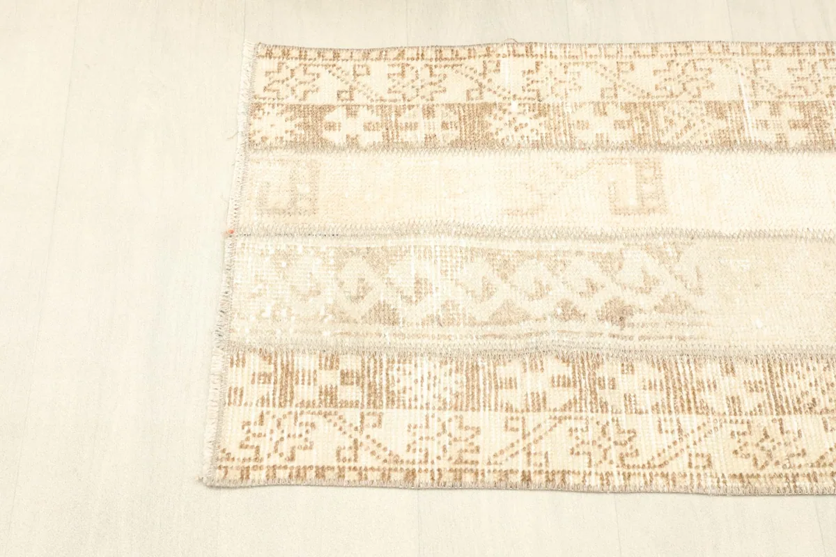 Overhead perspective of the rug, showcasing the full length and the continuity of its patchwork design.