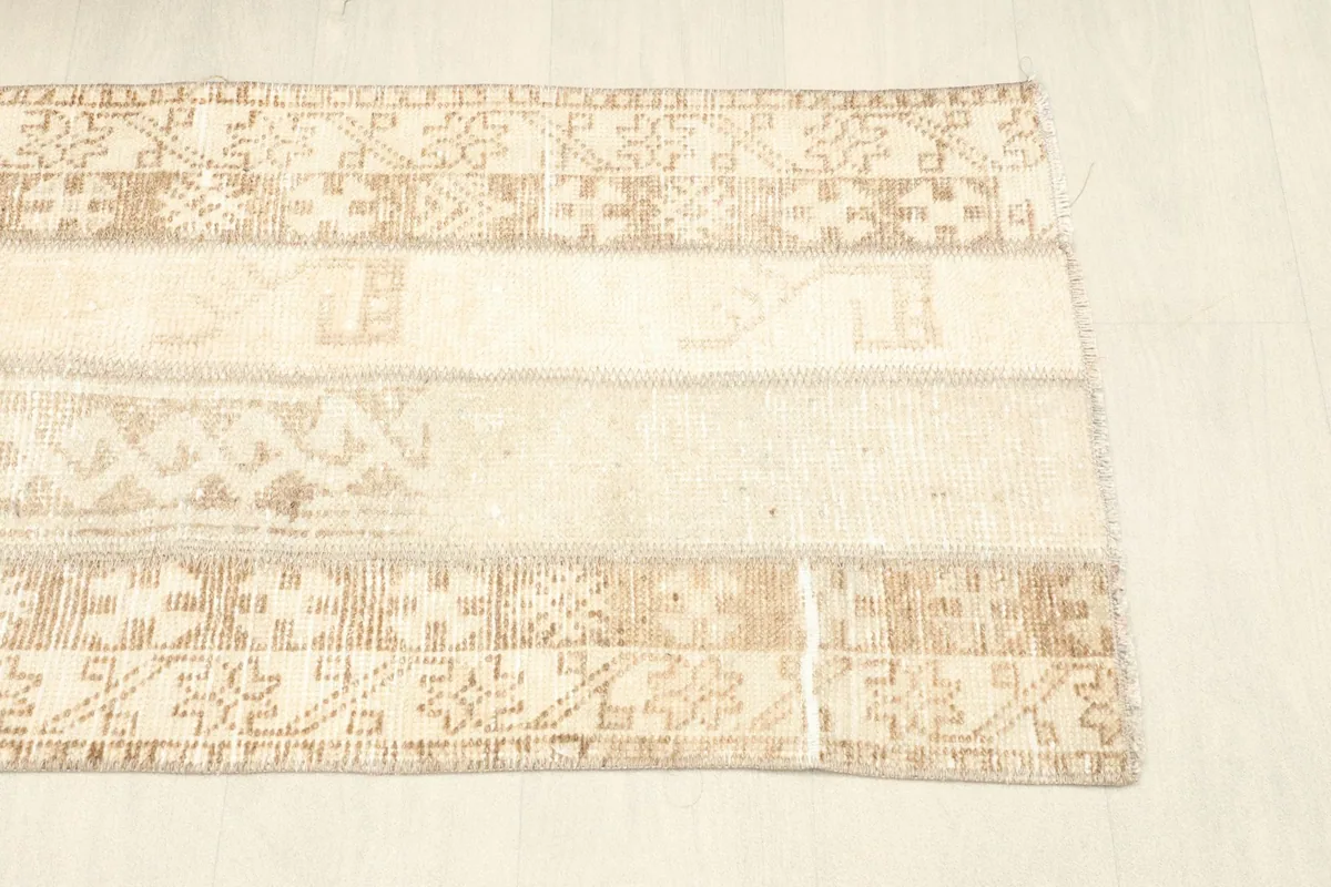 Another overhead shot of the rug, focusing on the blend of beige and tan tones and the distressed look.