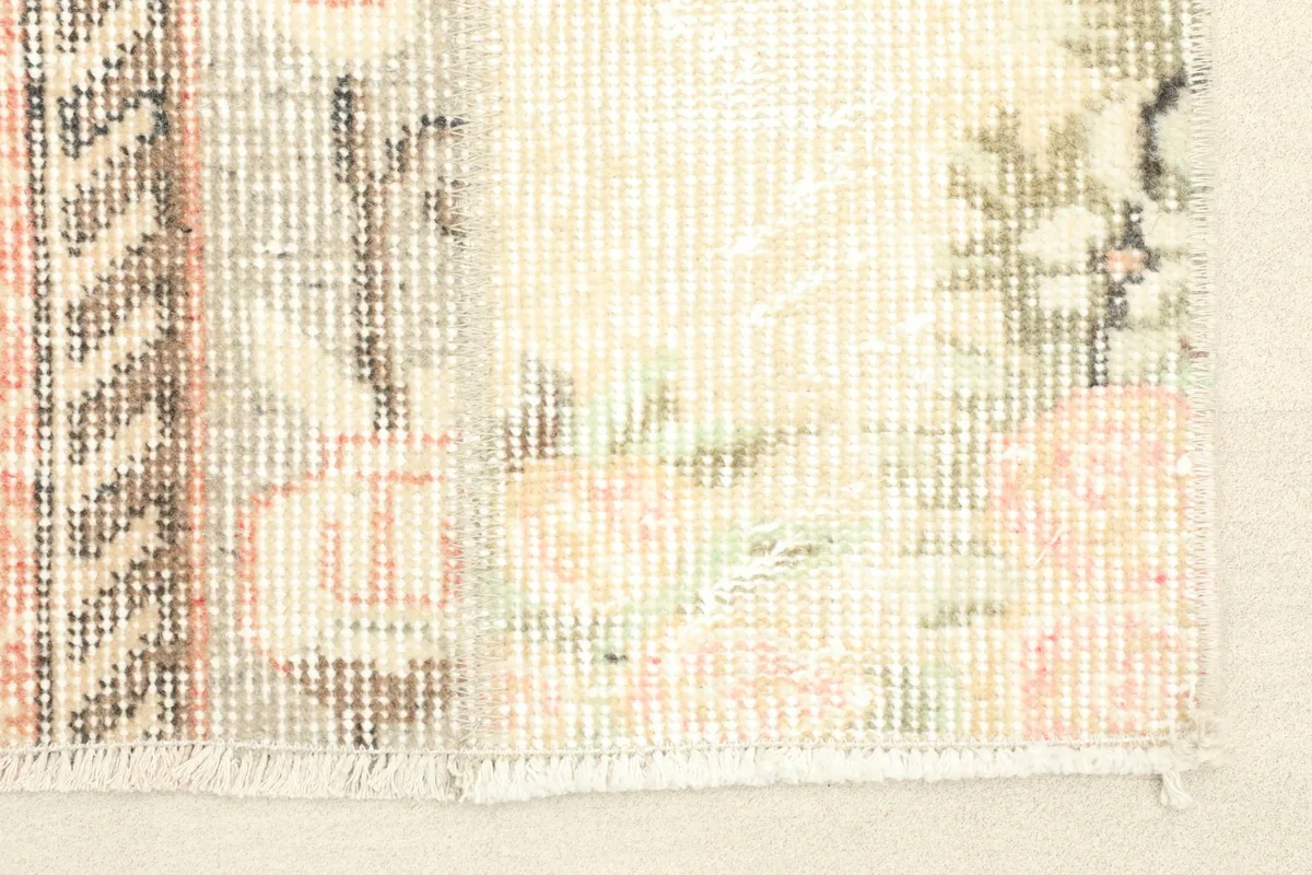 Close-up detail of the rug's texture, showing the low pile and varied patchwork sections.