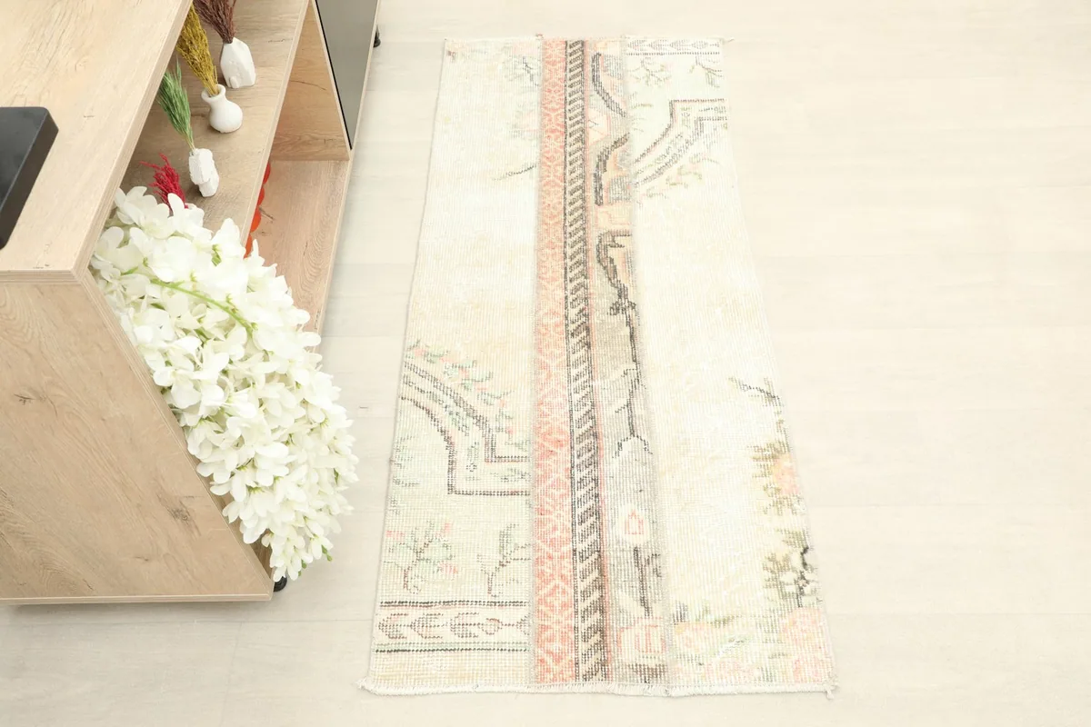 Overhead view of the vintage patchwork rug, showing its full design and colors.