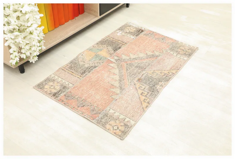 Full top view of a 2x4 rust patchwork geometric vintage rug on a white background.