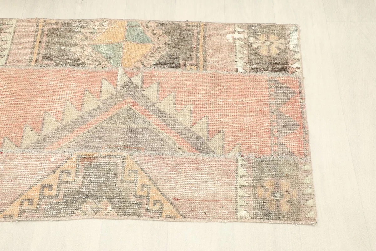 Another angled view of the rug, focusing on the blend of rust, charcoal, and beige tones.