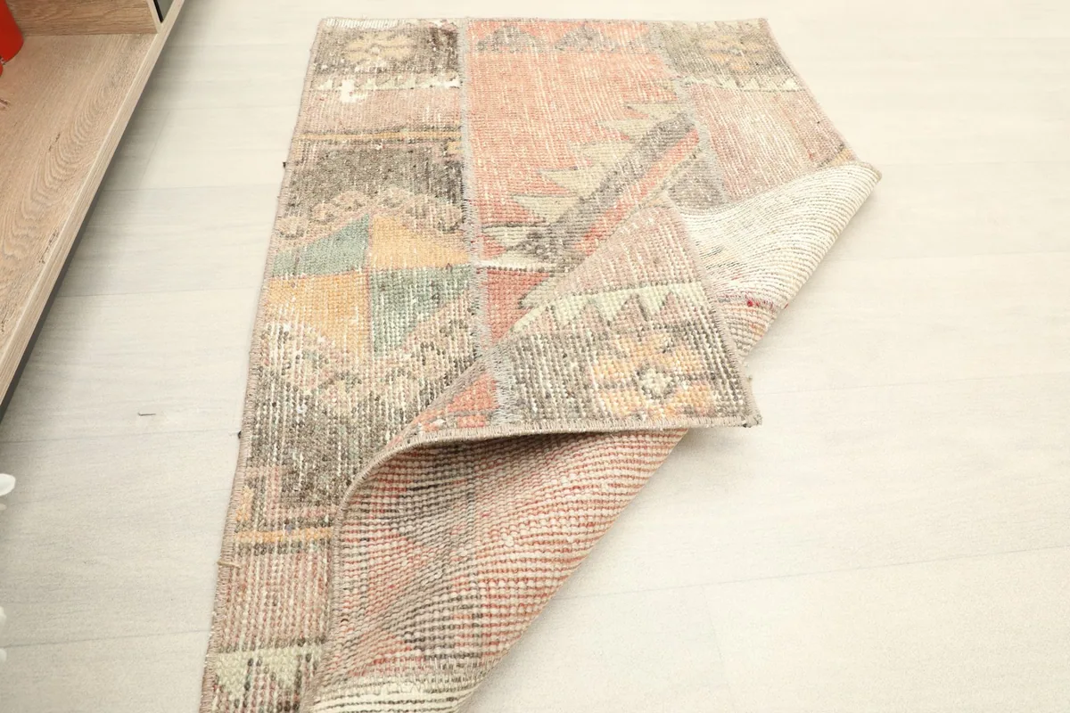 The rug partially folded, showing the flexibility and construction of the hand-knotted piece.
