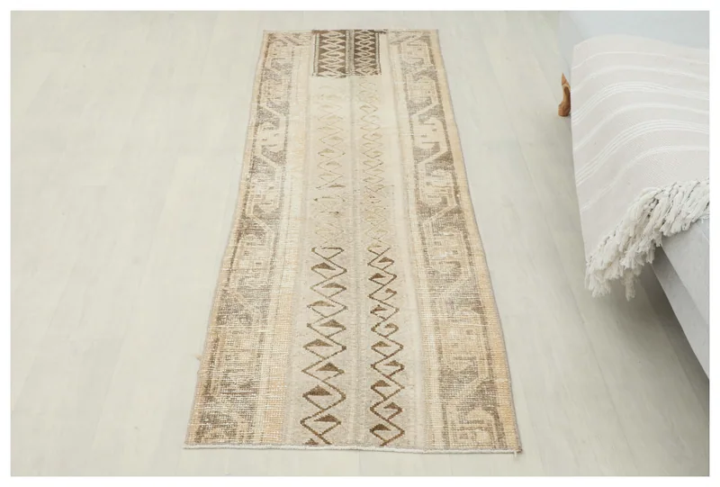 Full top view of the 2'2" x 6'4" vintage Anatolian runner rug on a white background.